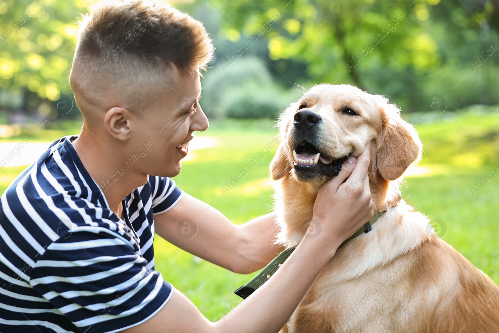 Photo of Young man with his lovely dog in park