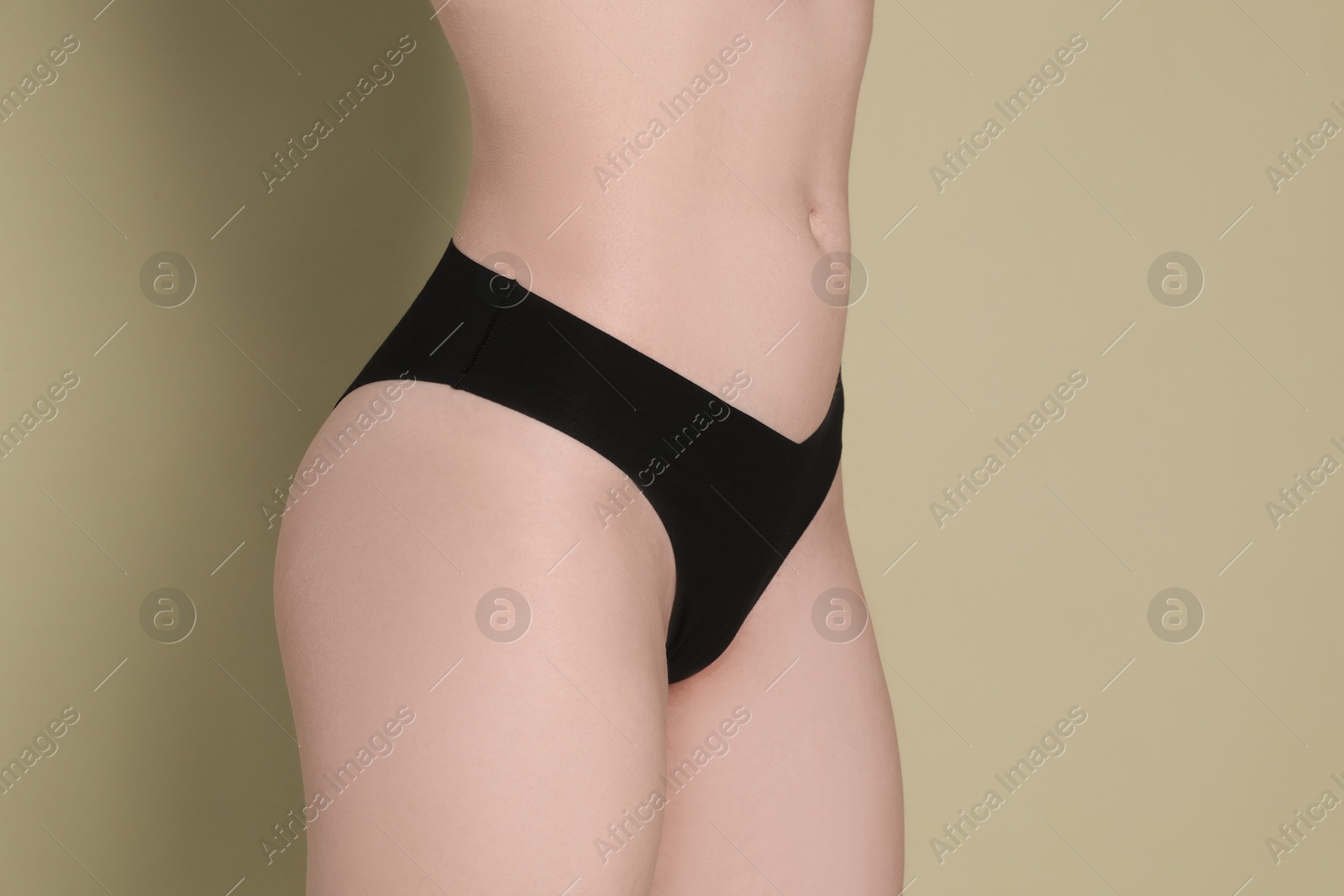 Photo of Woman with slim body posing on olive background, closeup