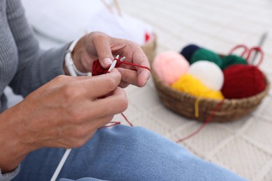 Photo of Woman knitting at home, closeup. Handicraft hobby