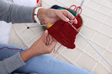 Photo of Woman knitting at home, closeup. Handicraft hobby