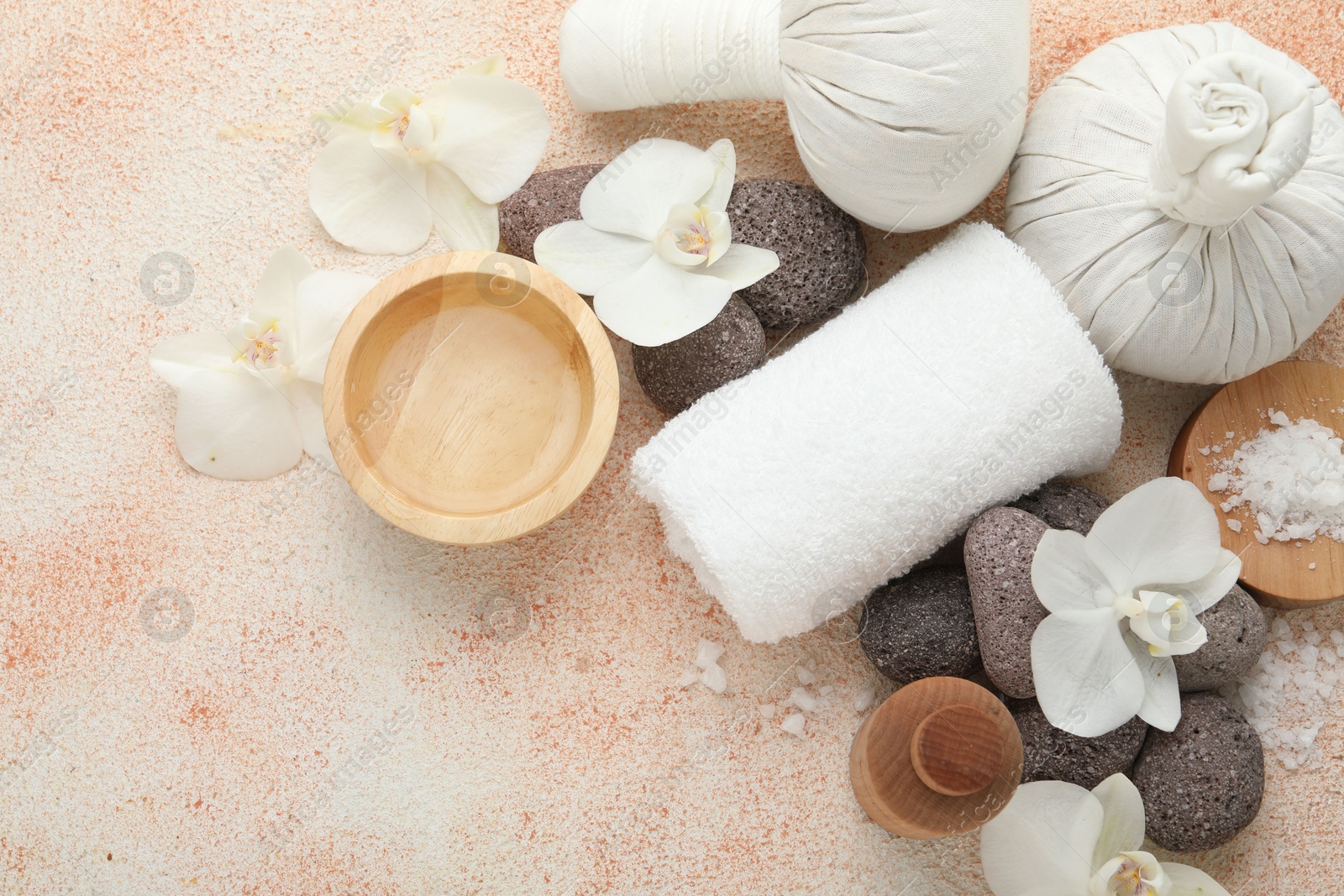 Photo of Flat lay composition with different spa products on beige textured background