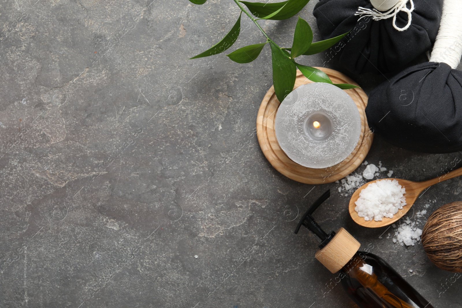 Photo of Flat lay composition with different spa products on grey textured table, space for text