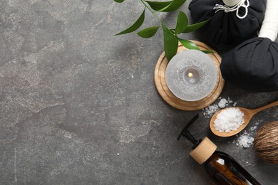 Flat lay composition with different spa products on grey textured table, space for text