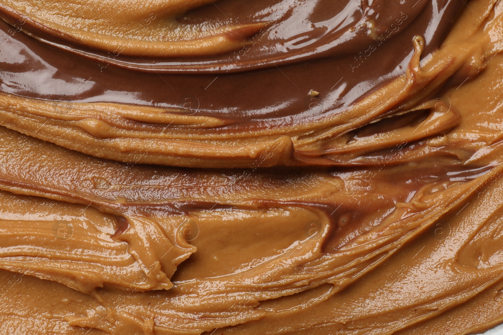 Photo of Tasty peanut butter as background, top view