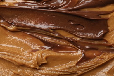 Photo of Tasty peanut butter as background, top view