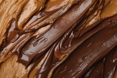 Photo of Tasty peanut butter as background, top view