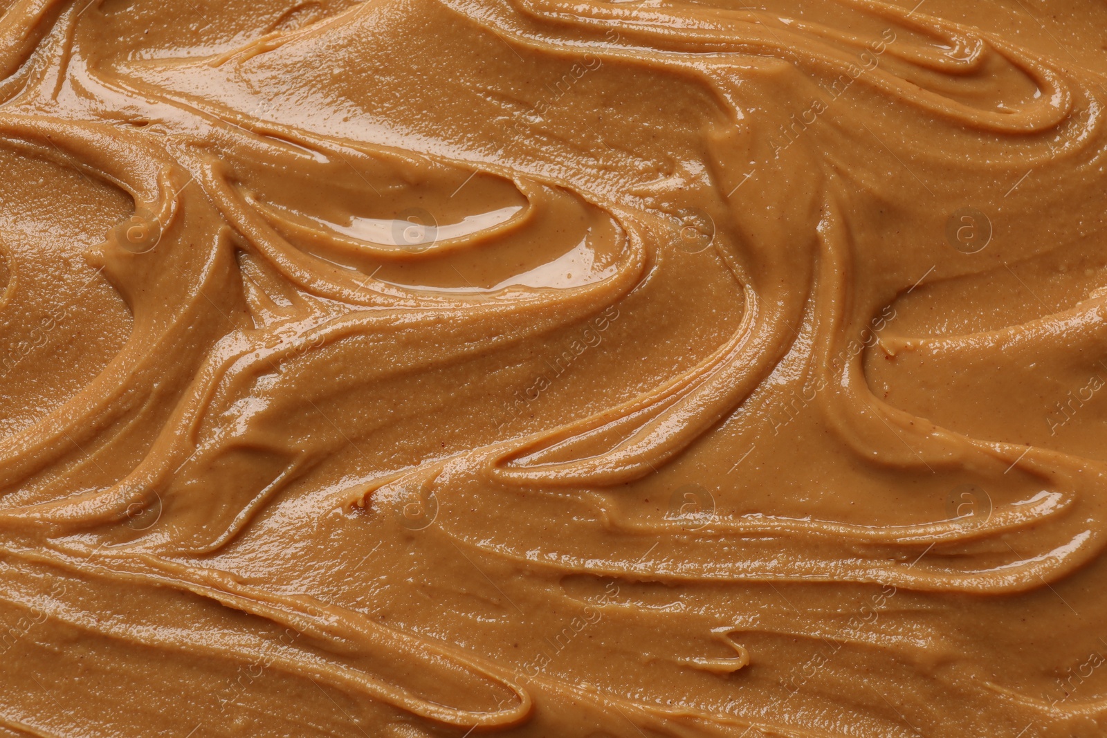 Photo of Tasty peanut butter as background, top view