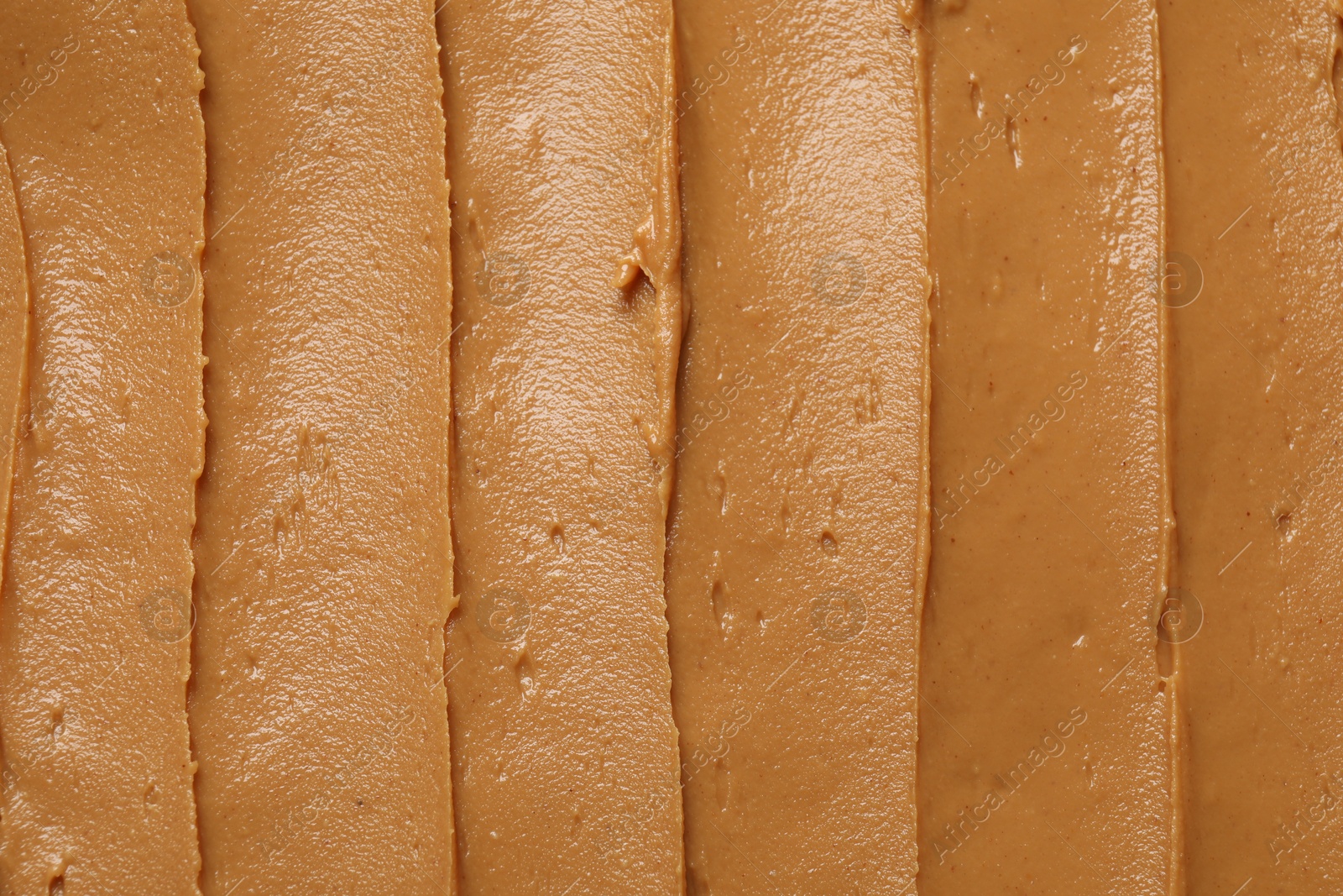 Photo of Tasty peanut butter as background, top view