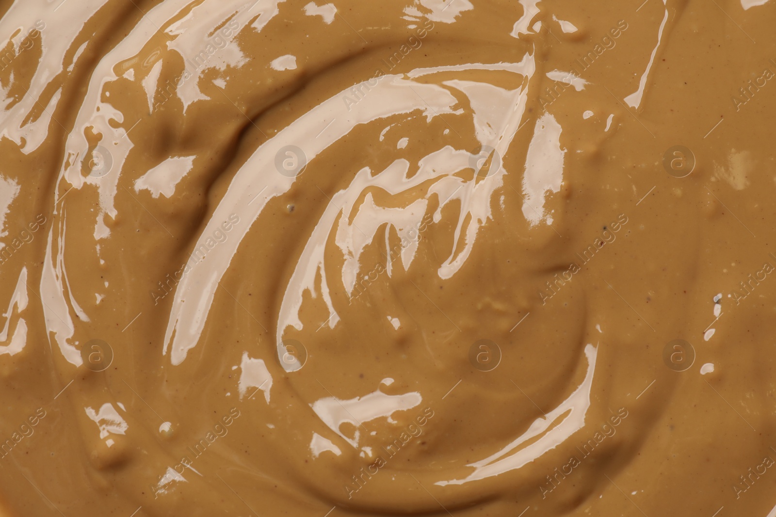 Photo of Tasty peanut butter as background, top view