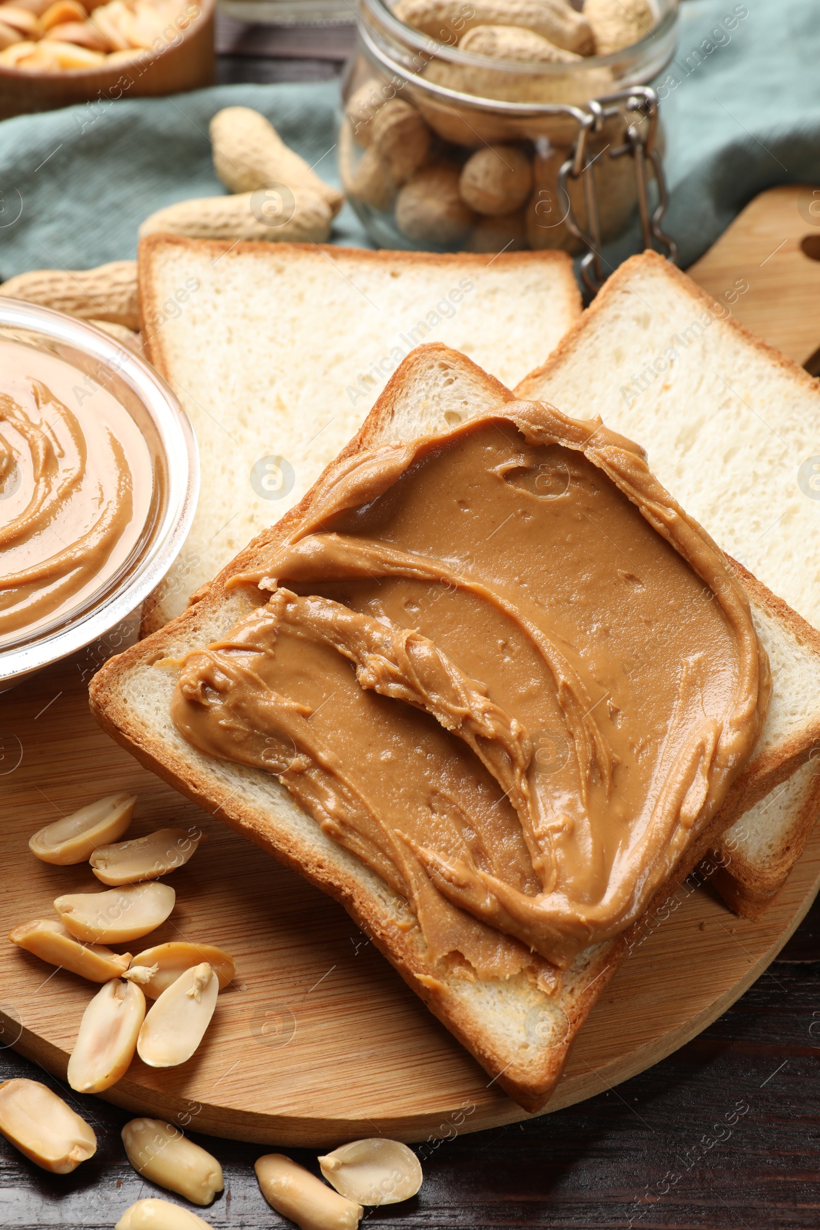 Photo of Delicious sandwich with peanut butter and nuts on table, closeup