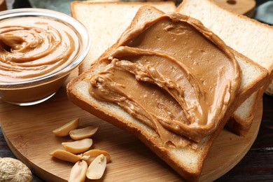 Delicious sandwich with peanut butter and nuts on table, closeup