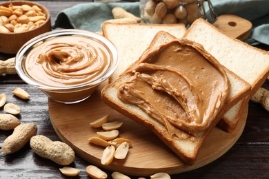 Delicious sandwich with peanut butter and nuts on wooden table, closeup