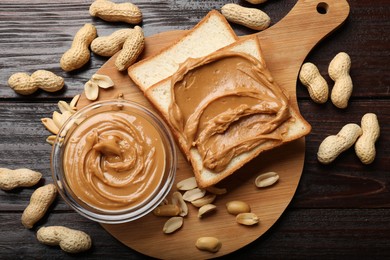 Delicious sandwich with peanut butter and nuts on wooden table, flat lay