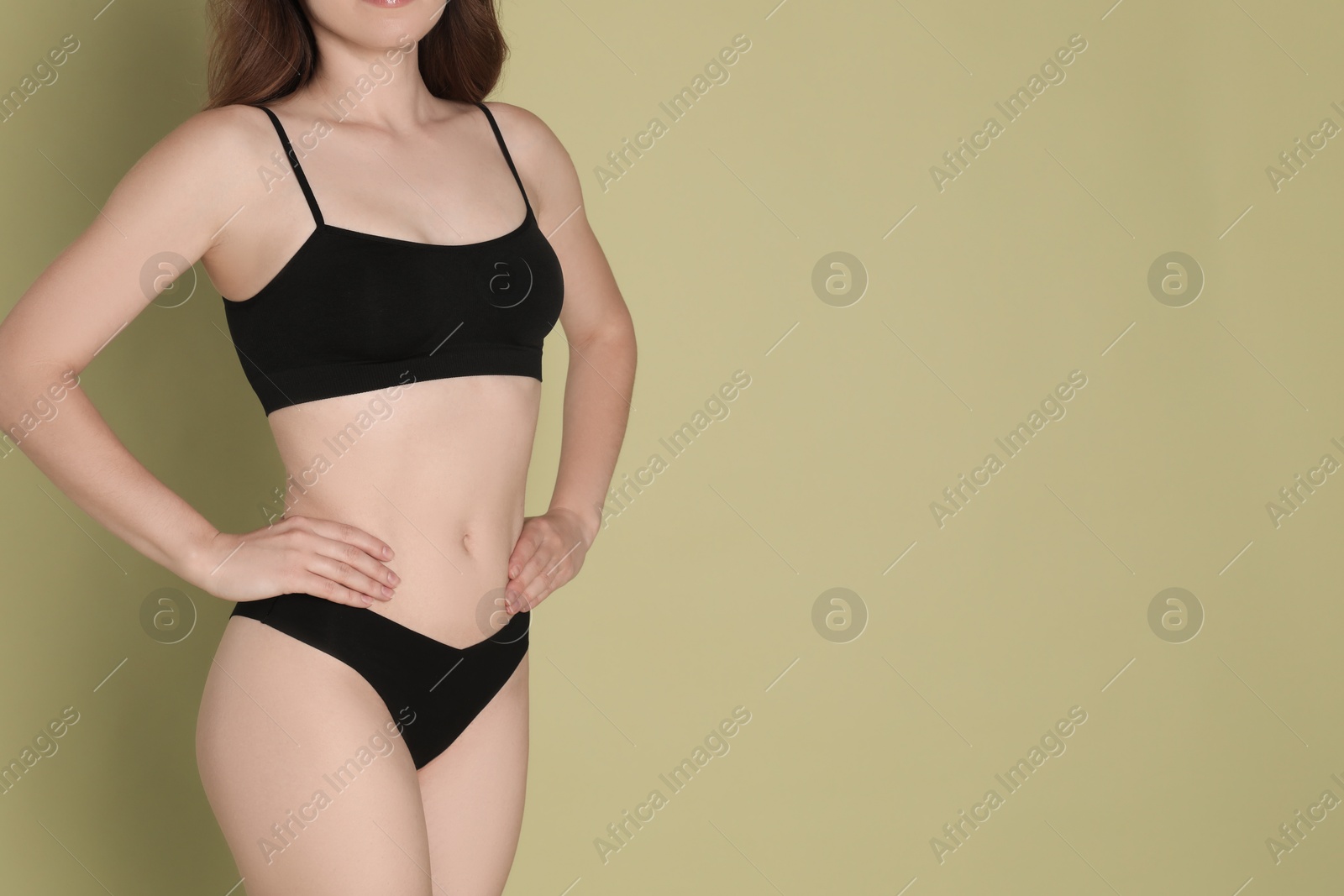 Photo of Woman with slim body posing on olive background, closeup. Space for text