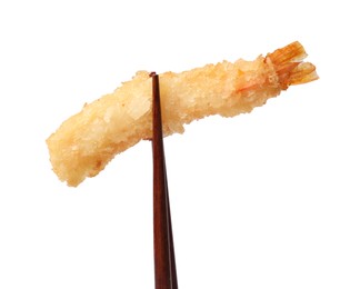 Photo of Chopsticks with delicious breaded fried shrimp isolated on white