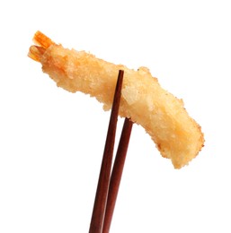 Photo of Chopsticks with delicious breaded fried shrimp isolated on white