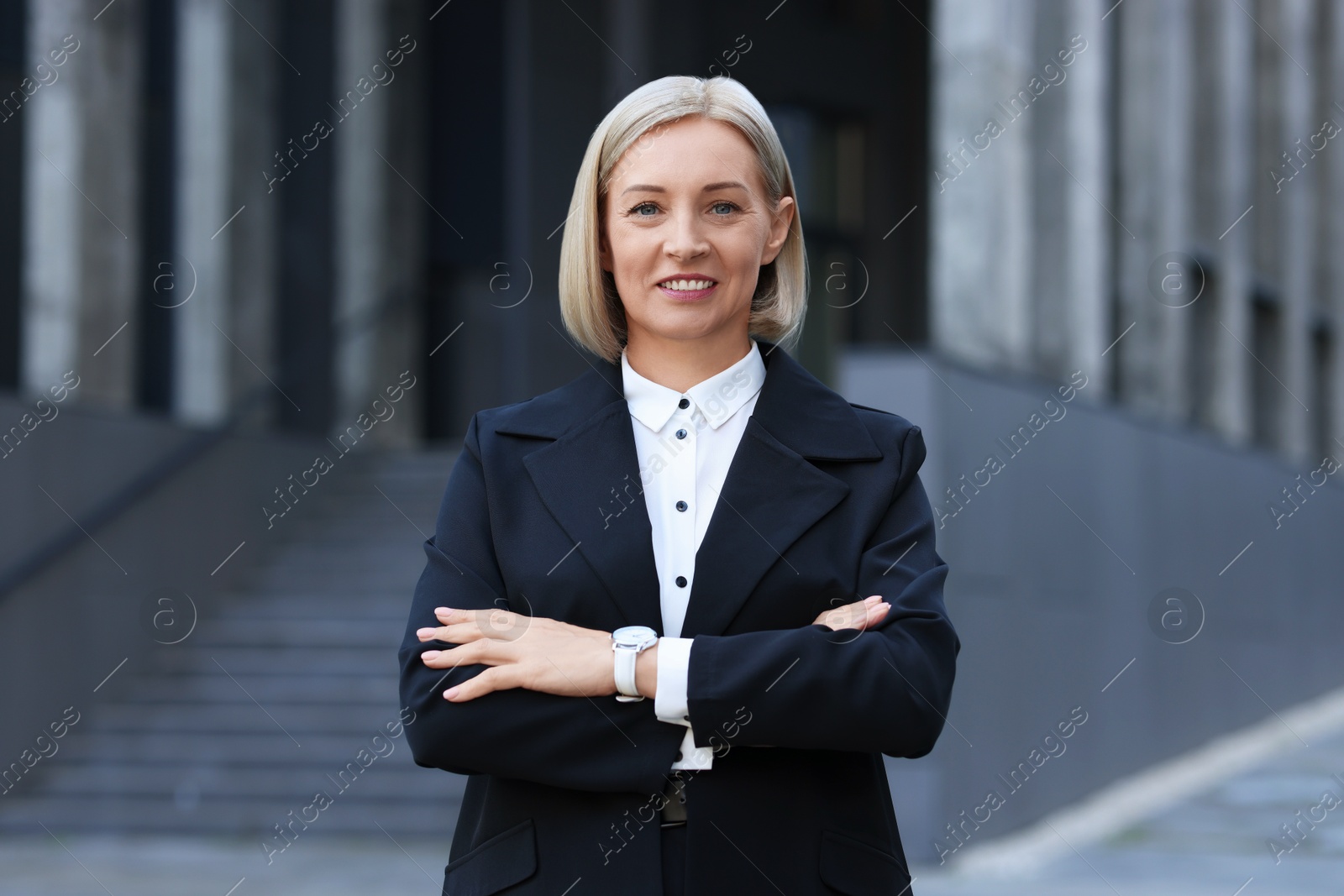 Photo of International relations. Diplomat with crossed arms in suit outdoors