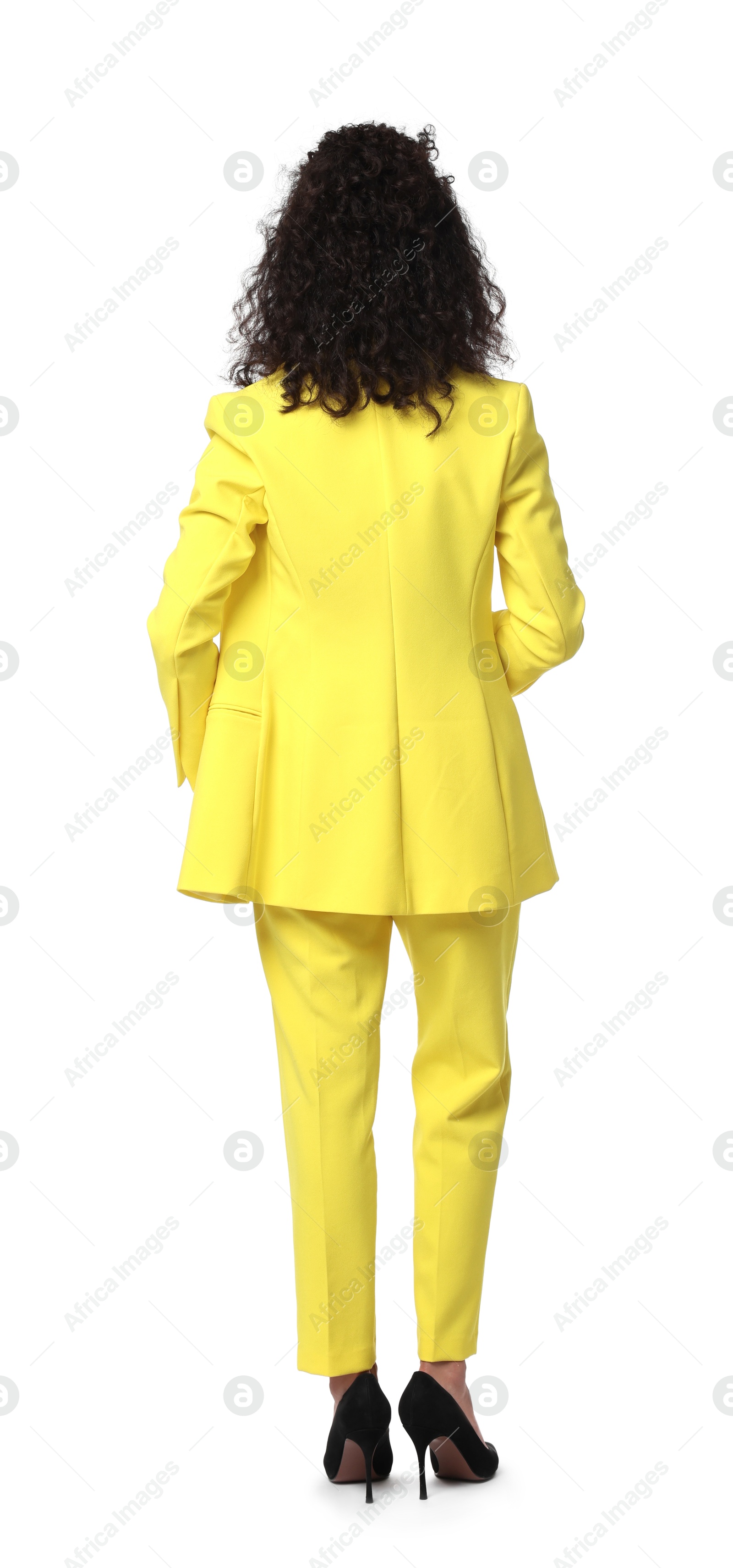 Photo of Woman in stylish yellow suit isolated on white, back view