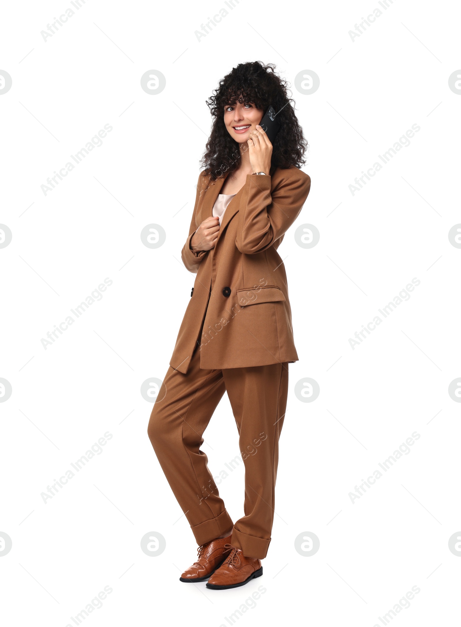 Photo of Beautiful young woman in stylish suit talking on smartphone against white background