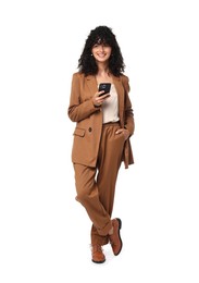 Beautiful young woman in stylish suit using smartphone on white background