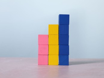 Blank colorful cubes on light grey marble table