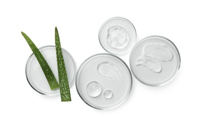 Photo of Petri dishes with different cosmetic products and aloe vera leaves isolated on white, flat lay