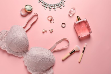 Photo of Elegant lace women's underwear, jewellery, cosmetics and perfume on pink background, flat lay