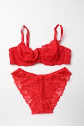 Elegant red lace women's underwear isolated on white, top view