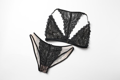 Elegant black lace women's underwear isolated on white, top view