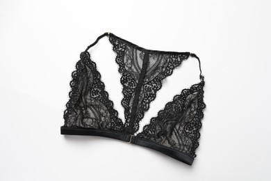 Elegant black lace women's underwear isolated on white, top view