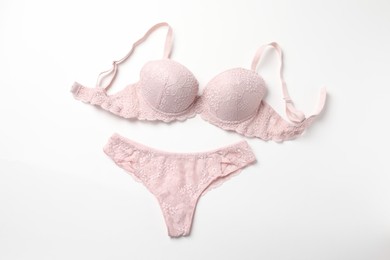 Elegant pink lace women's underwear isolated on white, top view