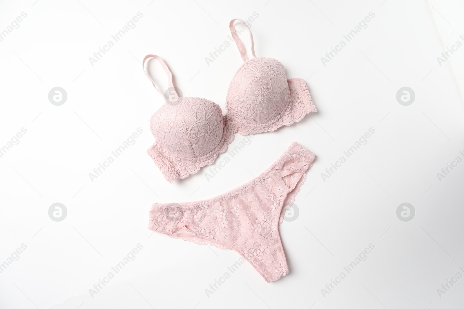 Photo of Elegant pink lace women's underwear isolated on white, top view