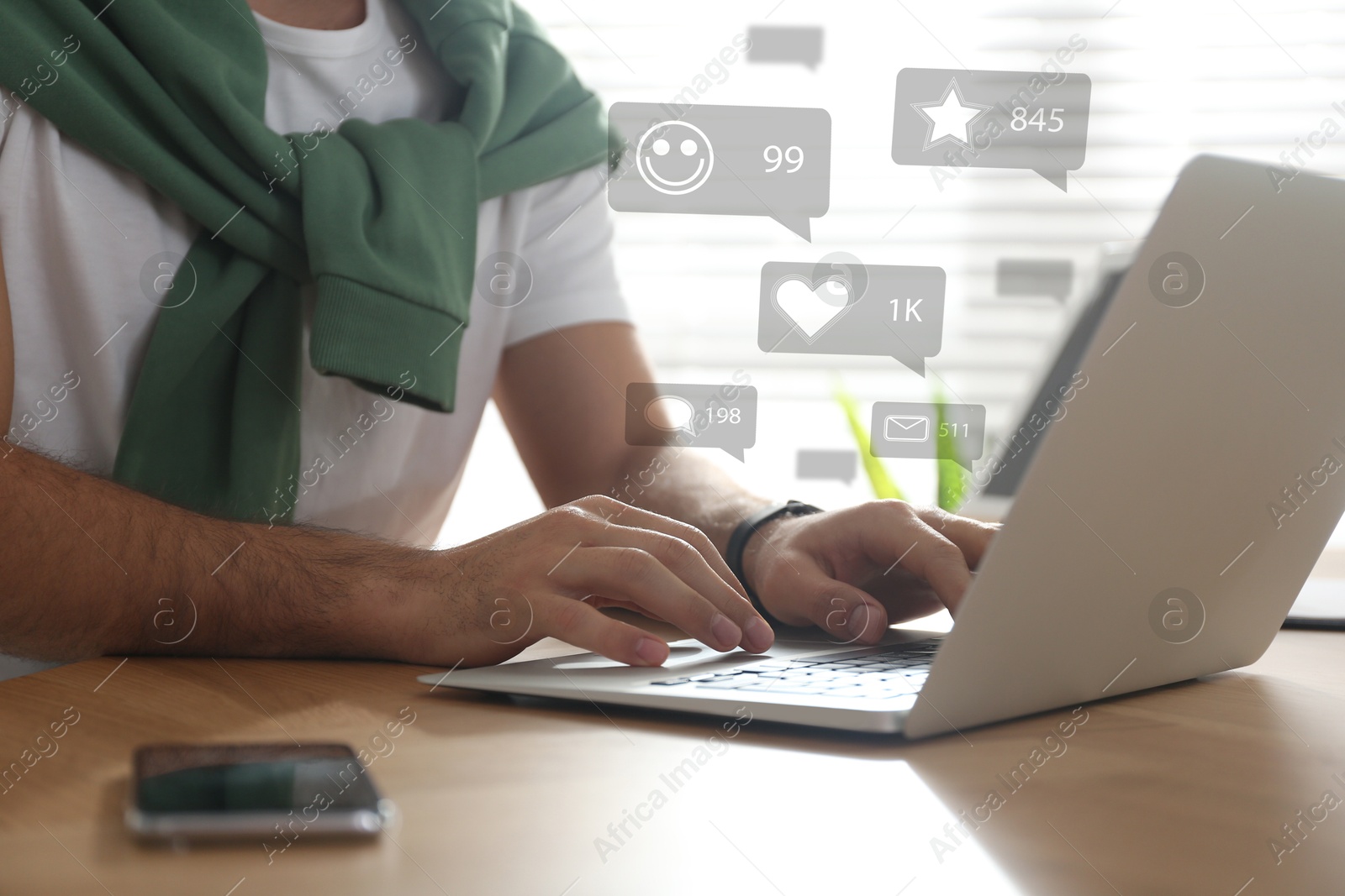 Image of Content manager. Man working on laptop indoors, closeup. Likes, followers, e-mails, messages and adding to favorite notifications over device