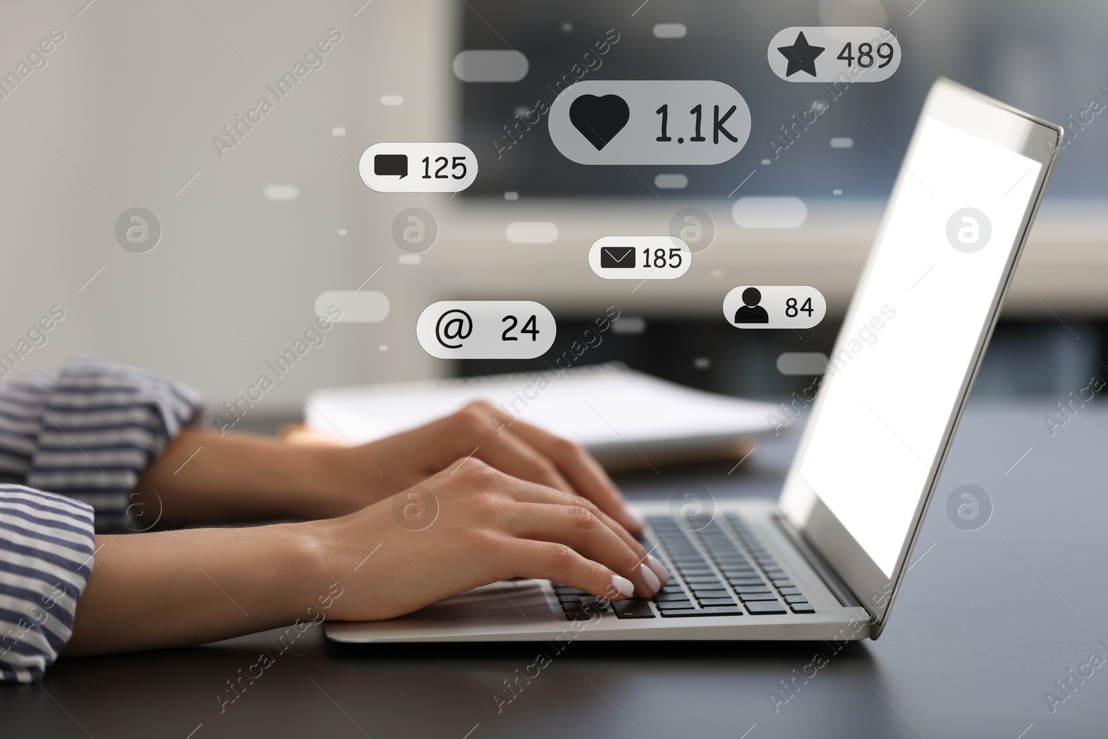 Image of Content manager. Woman working on laptop indoors, closeup. Likes, followers, e-mails, messages and adding to favorite notifications over device