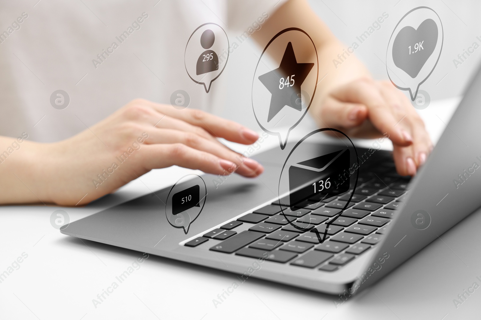 Image of Content manager. Woman working on laptop indoors, closeup. Likes, followers, e-mails, messages and adding to favorite notifications over device