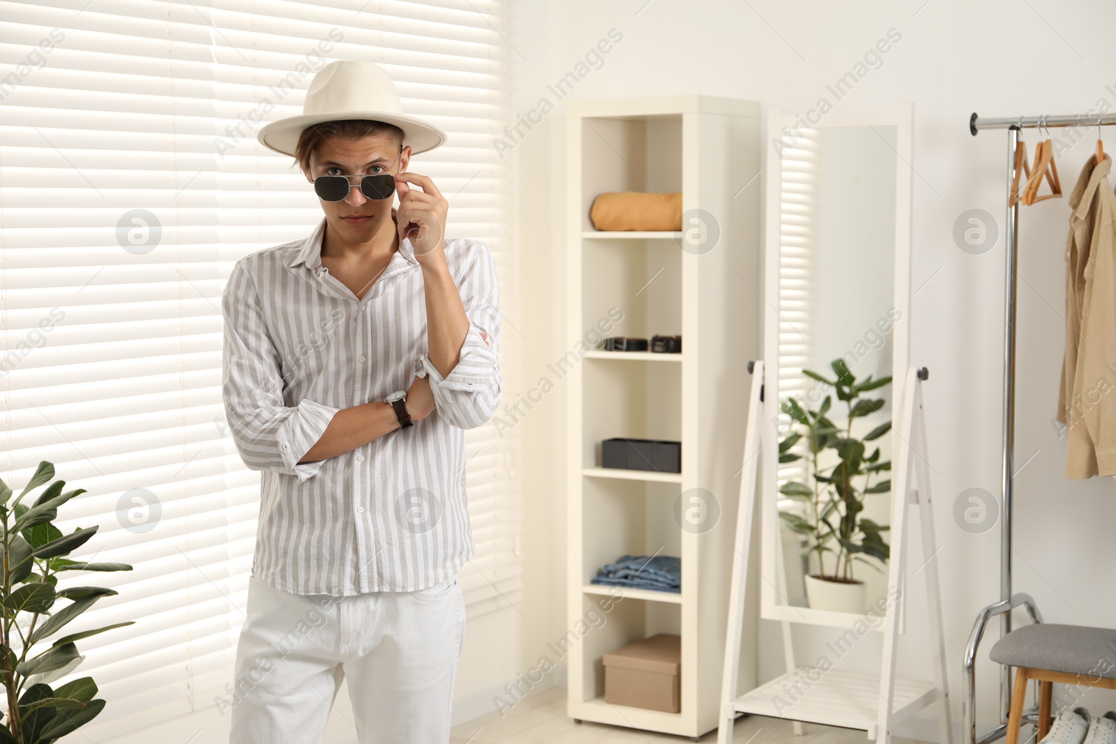 Photo of Handsome man in hat and glasses indoors