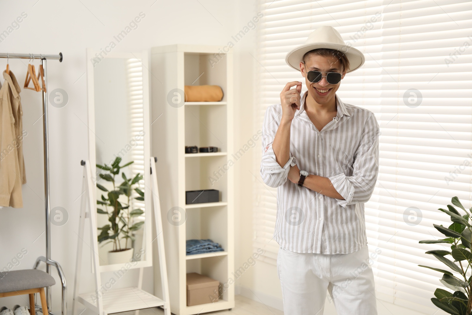 Photo of Handsome man in hat and glasses indoors