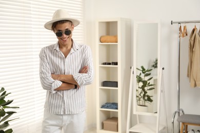 Photo of Handsome man in hat and glasses indoors