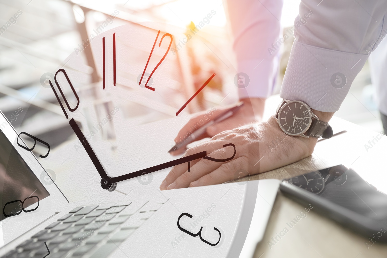 Image of Businessman working at table, clock, double exposure. Time management