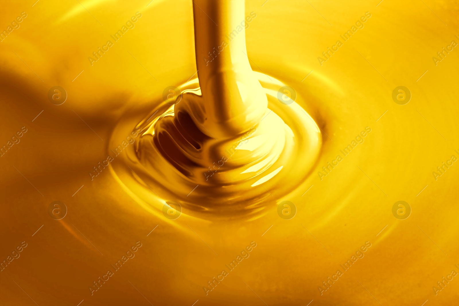 Image of Pouring gold fluid as background, closeup view