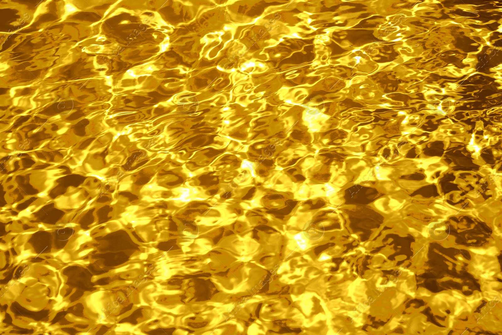 Image of Gold fluid with ripples as background, closeup