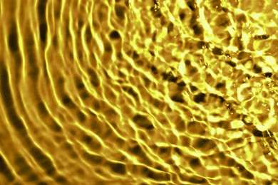 Image of Gold fluid with ripples as background, closeup