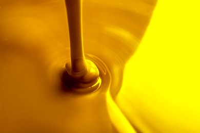 Image of Pouring gold fluid as background, closeup view