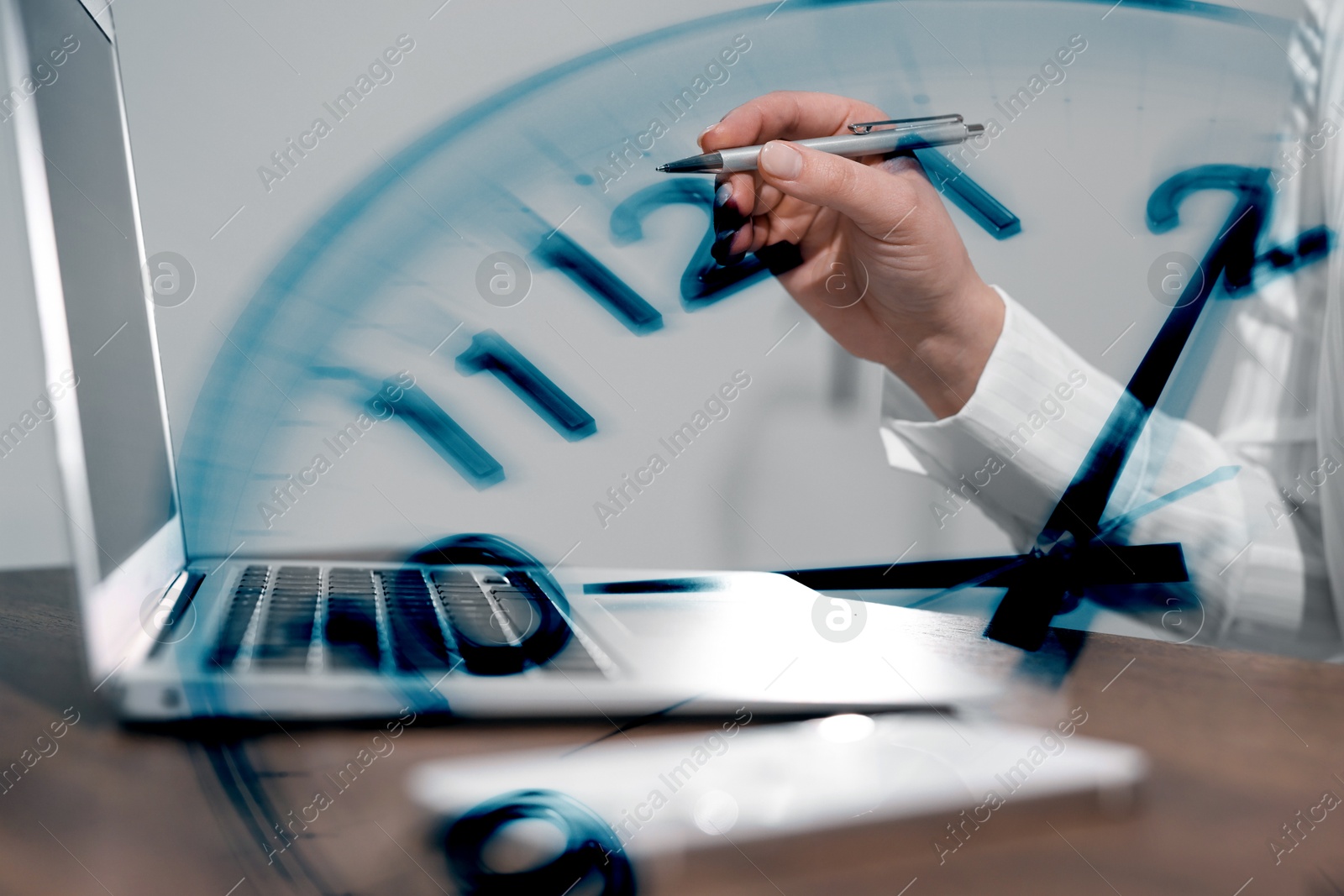 Image of Businesswoman working on laptop at table, clock, double exposure. Time management