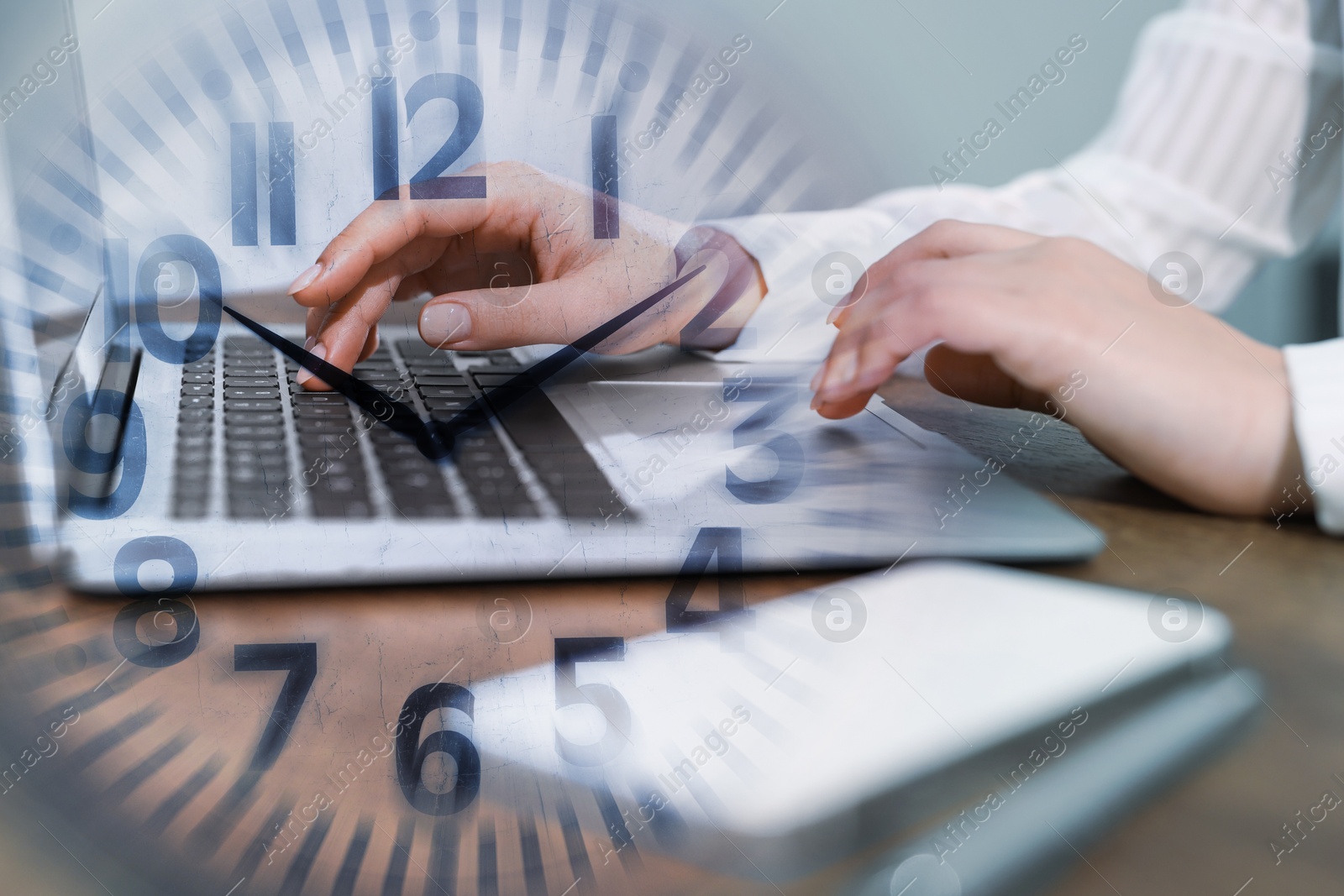 Image of Businesswoman working on laptop at table, clock, double exposure. Time management