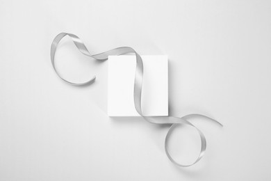 Beautiful grey ribbon and podium on white background, top view