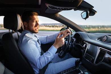 Photo of Man singing in car, view from inside