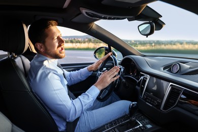 Man singing in car, view from inside