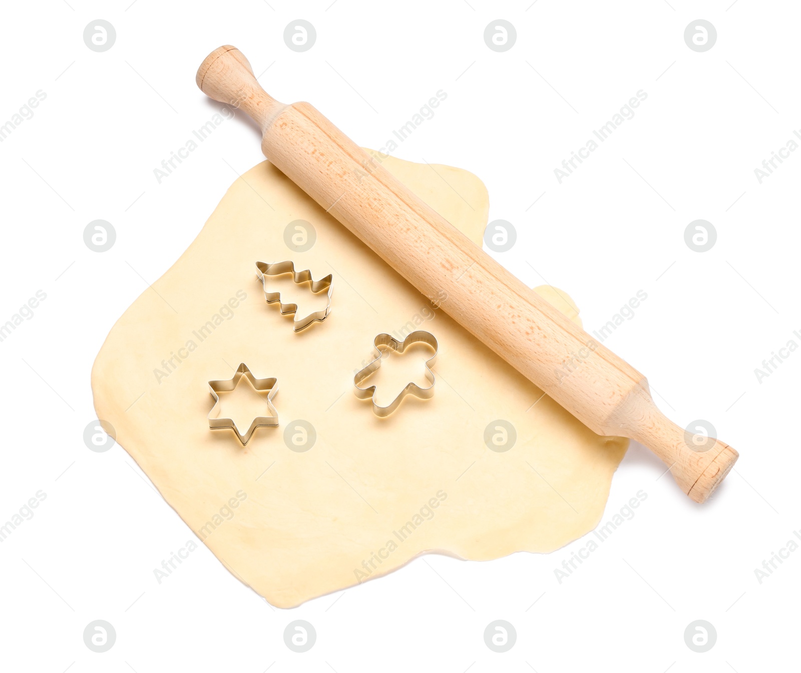 Photo of Raw dough, wooden rolling pin and cookie cutters isolated on white, top view