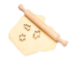 Raw dough, wooden rolling pin and cookie cutters isolated on white, top view